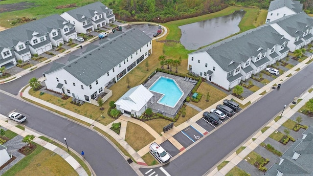 drone / aerial view with a water view and a residential view