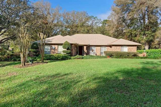 ranch-style home featuring brick siding and a front yard