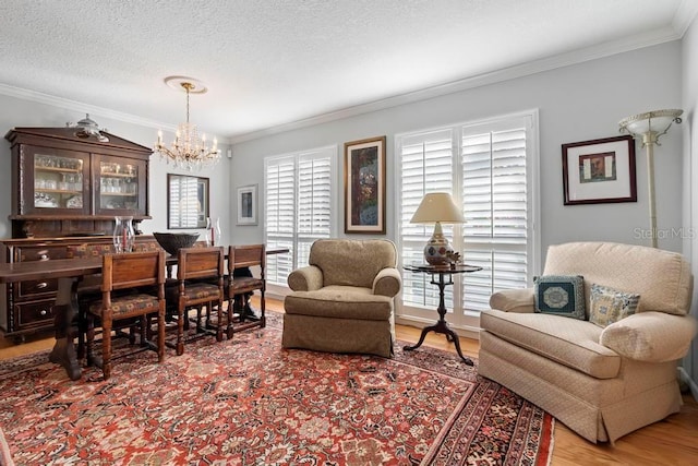 interior space with a notable chandelier, crown molding, a textured ceiling, and wood finished floors