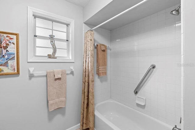 bathroom with shower / bath combo with shower curtain