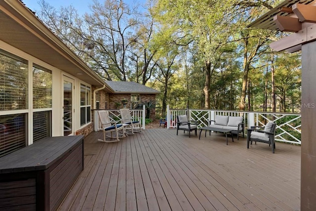 wooden terrace with an outdoor living space