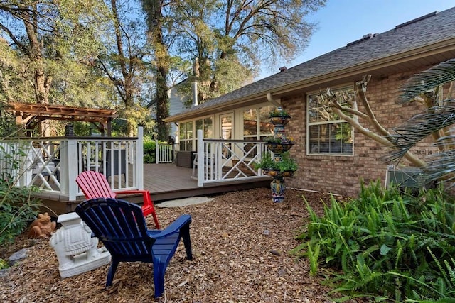 view of yard featuring a wooden deck and a pergola