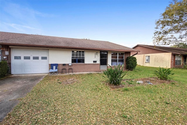 ranch-style house featuring a garage, driveway, brick siding, roof with shingles, and a front yard