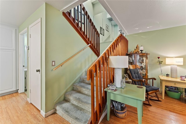 staircase featuring wood finished floors