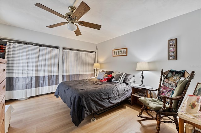 bedroom with light wood finished floors and a ceiling fan