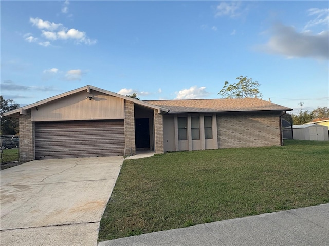 single story home featuring a front lawn and a garage