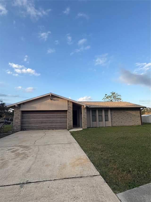 single story home with a front yard and a garage