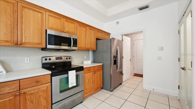 kitchen with appliances with stainless steel finishes and light tile patterned flooring