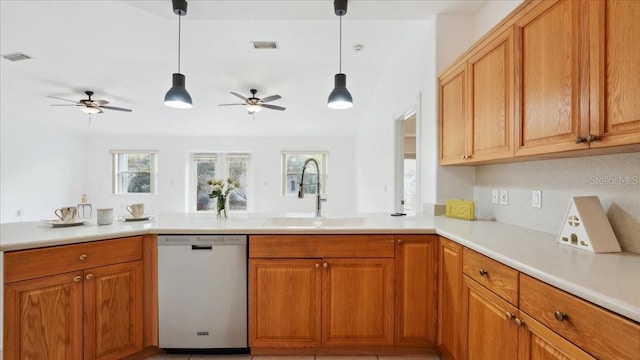 kitchen featuring kitchen peninsula, pendant lighting, dishwasher, and sink