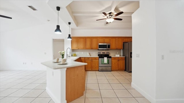 kitchen featuring light tile patterned floors, stainless steel appliances, pendant lighting, and kitchen peninsula