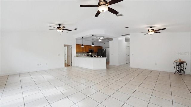 unfurnished living room with ceiling fan and light tile patterned floors