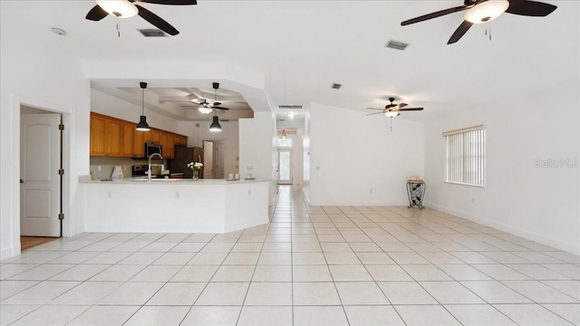 unfurnished living room with light tile patterned flooring and a wealth of natural light