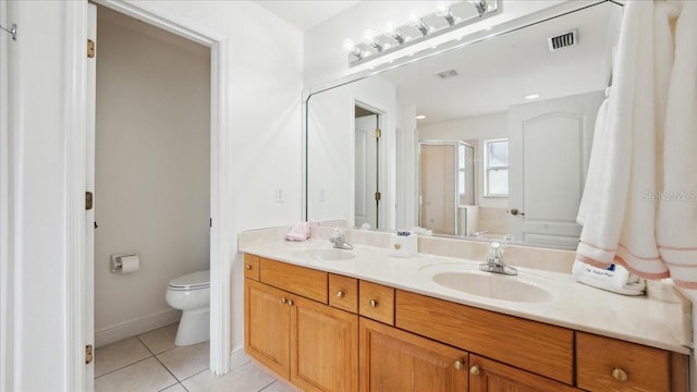 bathroom with vanity, an enclosed shower, toilet, and tile patterned floors