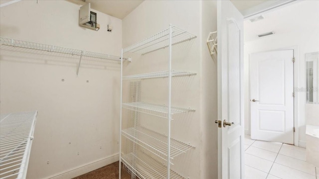 spacious closet featuring light tile patterned floors