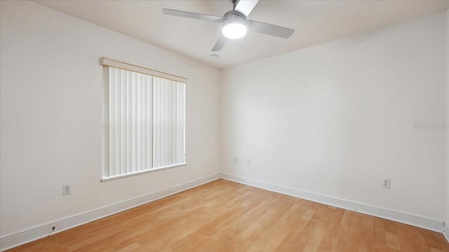 empty room with ceiling fan and light hardwood / wood-style flooring