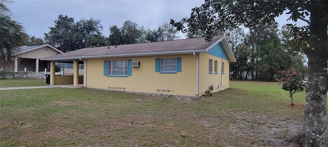 view of front of house with a front lawn, crawl space, and a wall unit AC