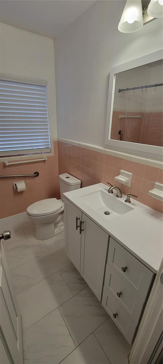 full bathroom with toilet, marble finish floor, a shower with shower curtain, and vanity