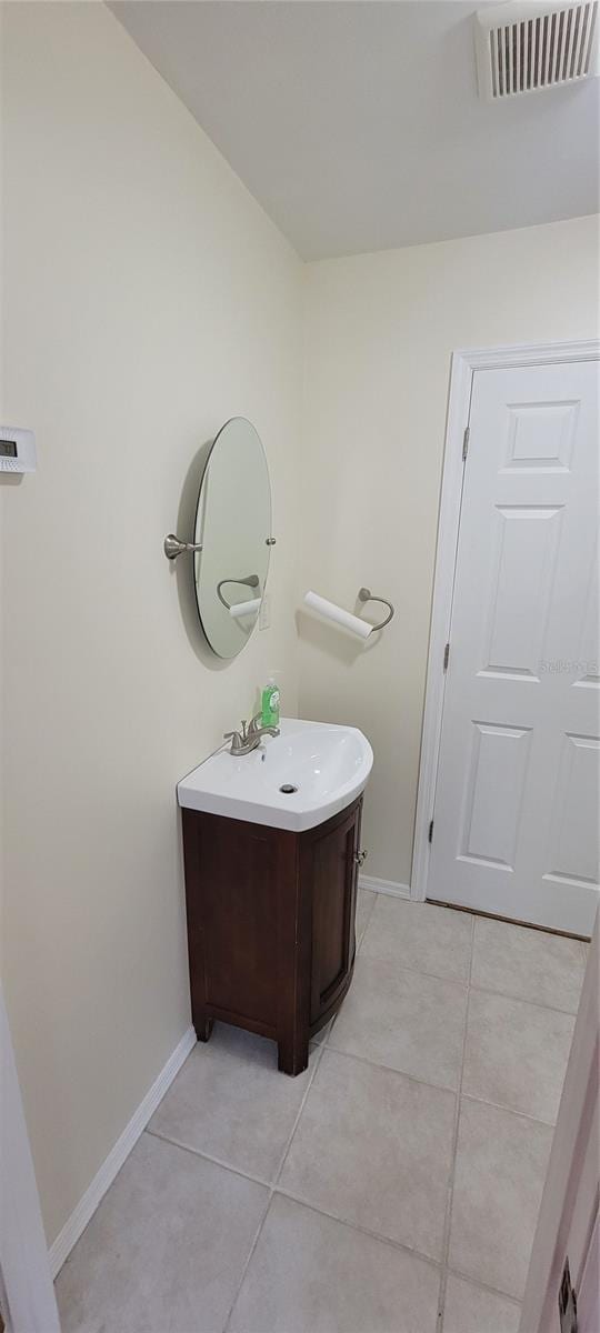 bathroom with tile patterned flooring, visible vents, vanity, and baseboards