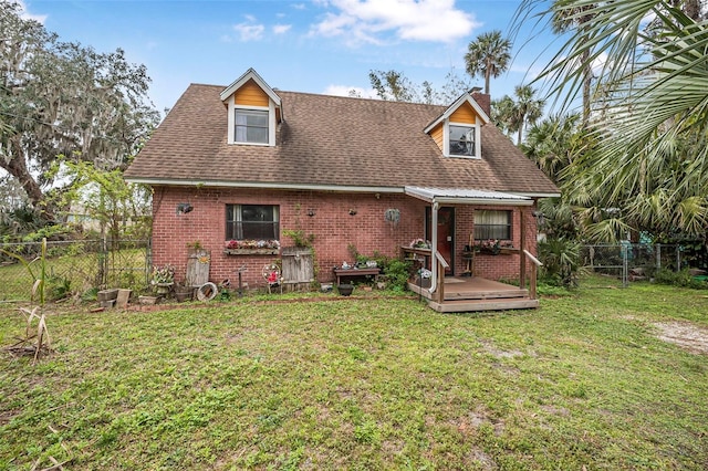 exterior space featuring fence private yard, brick siding, and a front lawn