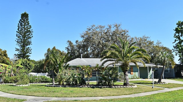 exterior space with concrete driveway and a yard