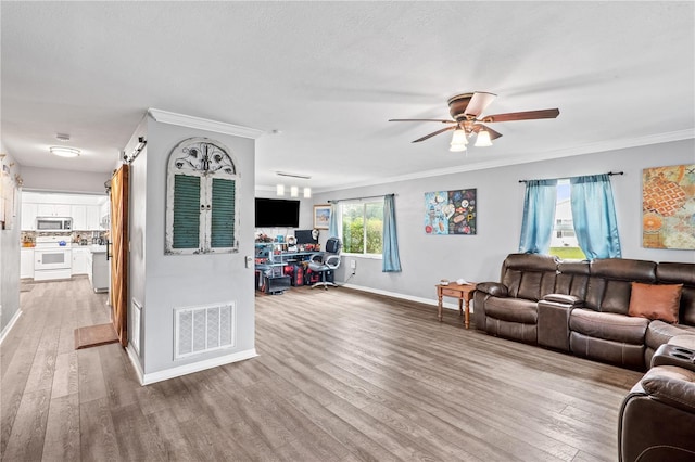 445 Virginia Ave, Saint Cloud, FL 34769 - living room featuring wood finished floors, baseboards, ceiling fan, and ornamental molding