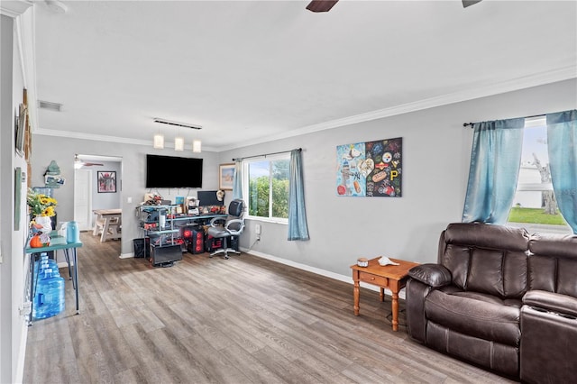 445 Virginia Ave, Saint Cloud, FL 34769 - living area with crown molding, wood finished floors, baseboards, and a ceiling fan