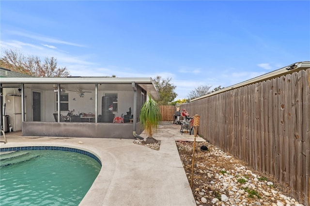 445 Virginia Ave, Saint Cloud, FL 34769 - back of property featuring a sunroom, a ceiling fan, a patio, and a fenced backyard