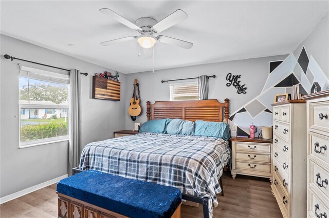 445 Virginia Ave, Saint Cloud, FL 34769 - bedroom with multiple windows, dark wood-style flooring, ceiling fan, and baseboards