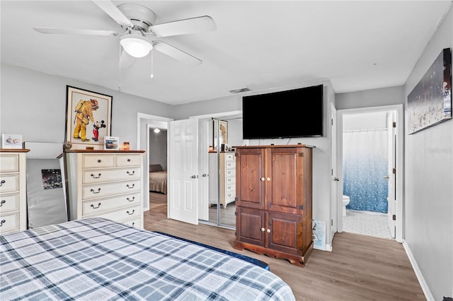 445 Virginia Ave, Saint Cloud, FL 34769 - bedroom featuring light wood-type flooring, baseboards, a ceiling fan, and connected bathroom