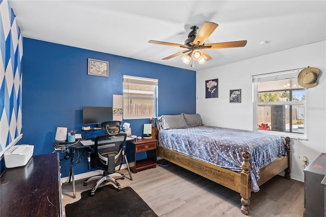 445 Virginia Ave, Saint Cloud, FL 34769 - bedroom featuring wood finished floors, an office area, ceiling fan, and baseboards