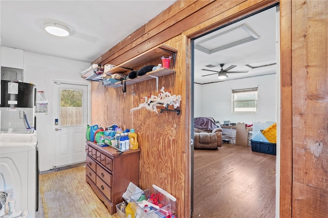 445 Virginia Ave, Saint Cloud, FL 34769 - laundry room featuring washer / clothes dryer, light wood-type flooring, and water heater