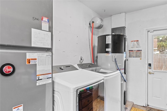 445 Virginia Ave, Saint Cloud, FL 34769 - clothes washing area with independent washer and dryer, heating unit, and heat pump water heater