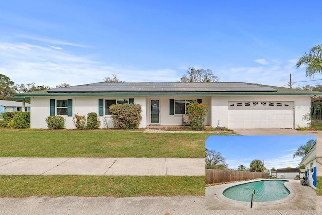 445 Virginia Ave, Saint Cloud, FL 34769 - single story home with stucco siding, roof mounted solar panels, and a garage