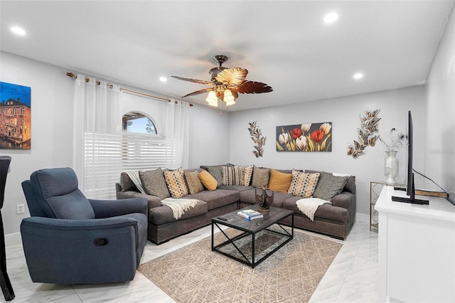 living room with a ceiling fan, recessed lighting, marble finish floor, and baseboards