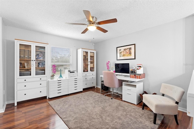 office space with a ceiling fan, dark wood finished floors, and a textured ceiling