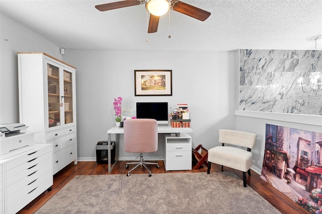 office featuring dark wood-style floors, a textured ceiling, baseboards, and a ceiling fan