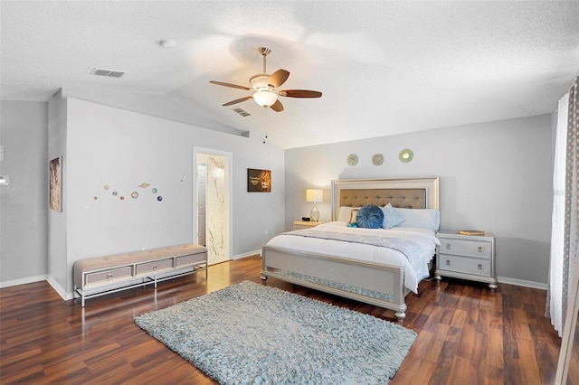 bedroom featuring dark wood-style floors, visible vents, vaulted ceiling, and baseboards