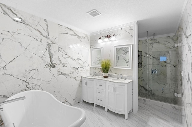 full bathroom with a marble finish shower, a freestanding bath, a textured ceiling, and a sink