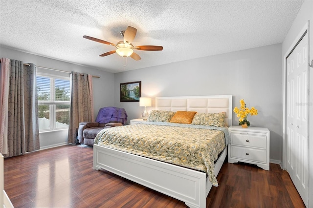 bedroom featuring dark wood-type flooring, a closet, a ceiling fan, and baseboards