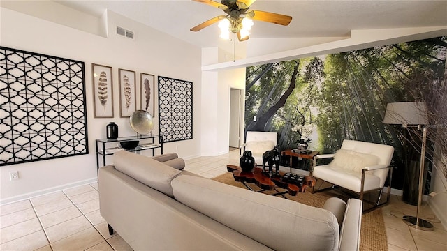 living room with light tile patterned floors, visible vents, a ceiling fan, vaulted ceiling, and baseboards