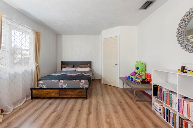 bedroom featuring visible vents and light wood-style floors