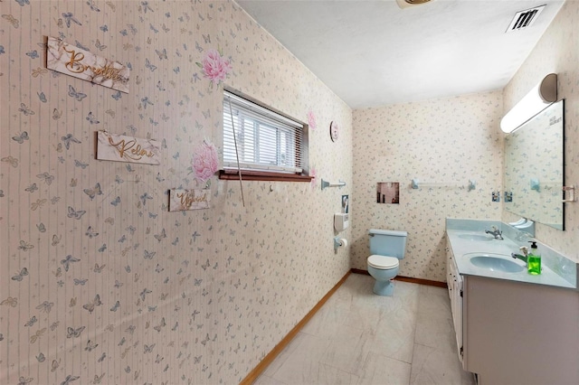 bathroom with baseboards, visible vents, a sink, and toilet