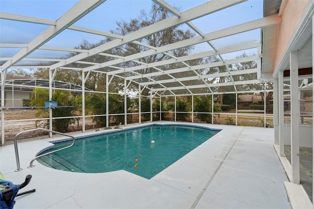 pool with a lanai and a patio area