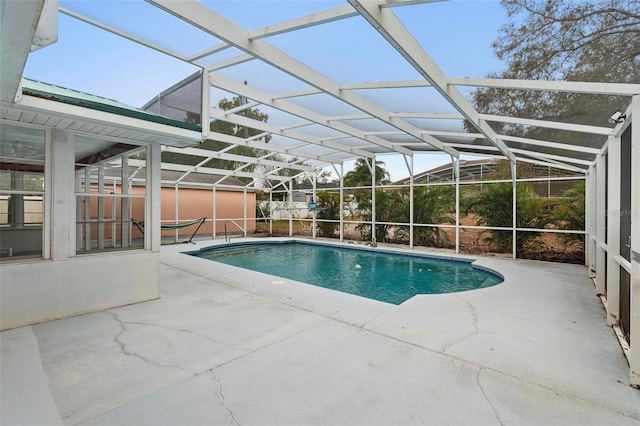 outdoor pool with a lanai and a patio area