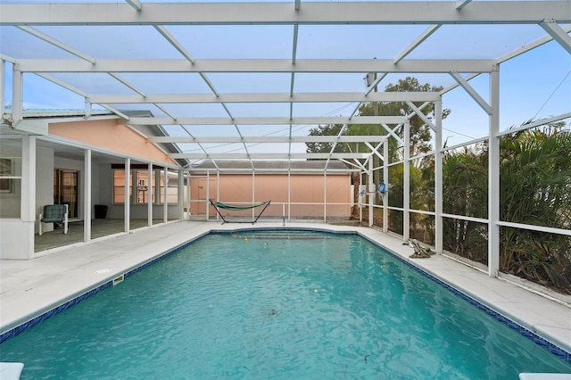 outdoor pool with a lanai and a patio area