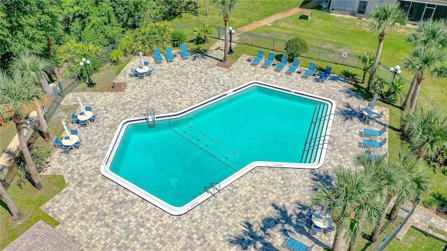 view of swimming pool with fence and a patio