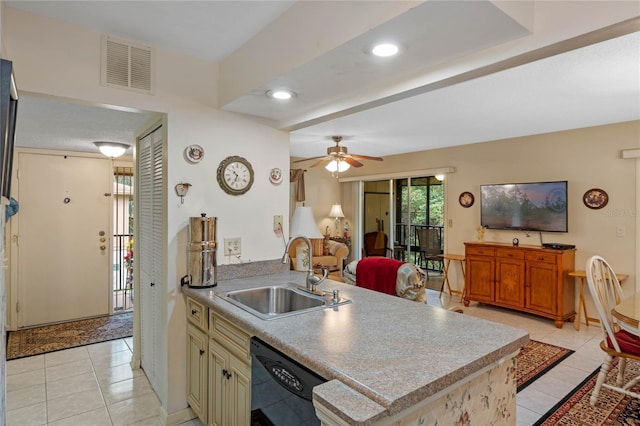 kitchen featuring black dishwasher, light countertops, a sink, and visible vents