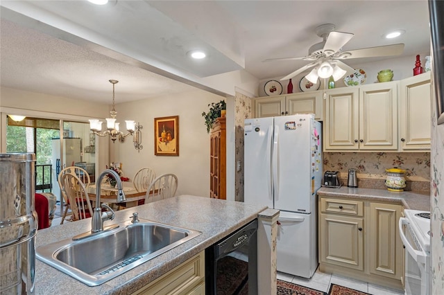 kitchen with light tile patterned flooring, white appliances, a sink, hanging light fixtures, and cream cabinetry