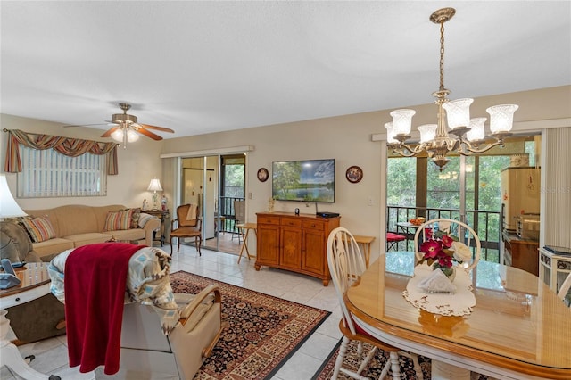 interior space featuring light tile patterned floors and ceiling fan with notable chandelier