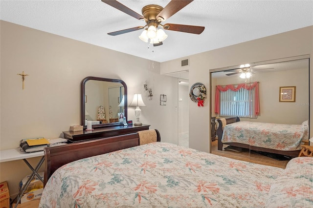 bedroom featuring ceiling fan, a textured ceiling, a closet, and visible vents